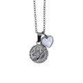 Silver necklace with a circle cherub pendant and a smaller heart charm on a chain