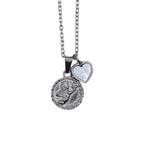 Silver necklace with a circle cherub pendant and a smaller heart charm on a chain